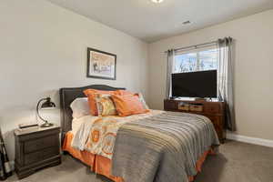 Carpeted bedroom with baseboards