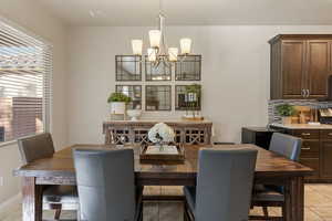 Dining space featuring a chandelier and light tile patterned floors
