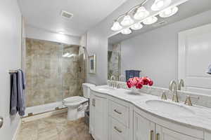 Bathroom with double vanity and a stall shower