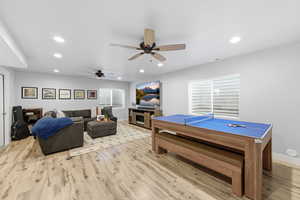 Game room with ceiling fan, light wood finished floors, and recessed lighting
