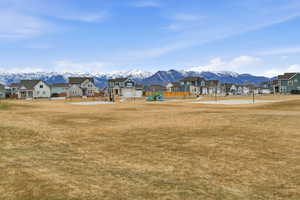 View of property's community with a lawn, a mountain view, and a residential view