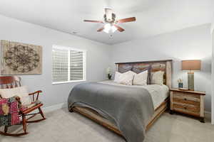 Bedroom featuring light colored carpet and ceiling fan