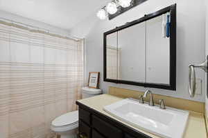 Full bath with vanity and a shower with shower curtain