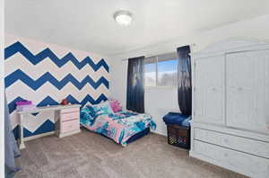 Bedroom featuring light colored carpet and baseboards