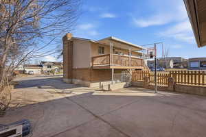 Rear view of property with a residential view, a chimney, and a balcony
