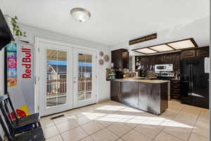 Kitchen with dark wood finish cabinets, french doors