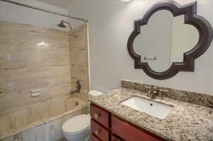 Bathroom with vanity and tub / shower combination