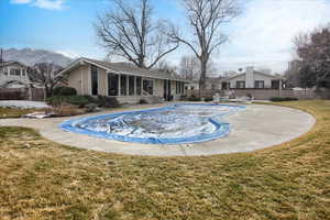 View of swimming pool with a sunroom and a patio area