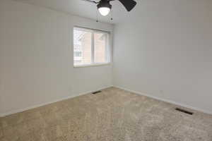Spare room with carpet flooring and ceiling fan