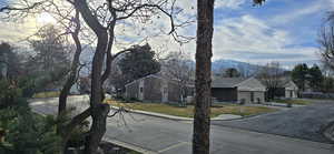 View of asphalt road with curbs and a mountain view