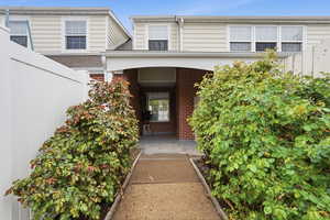 Private entrance with flower beds.