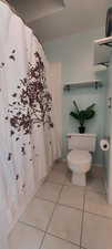 Bathroom featuring a shower with curtain and light tile patterned flooring