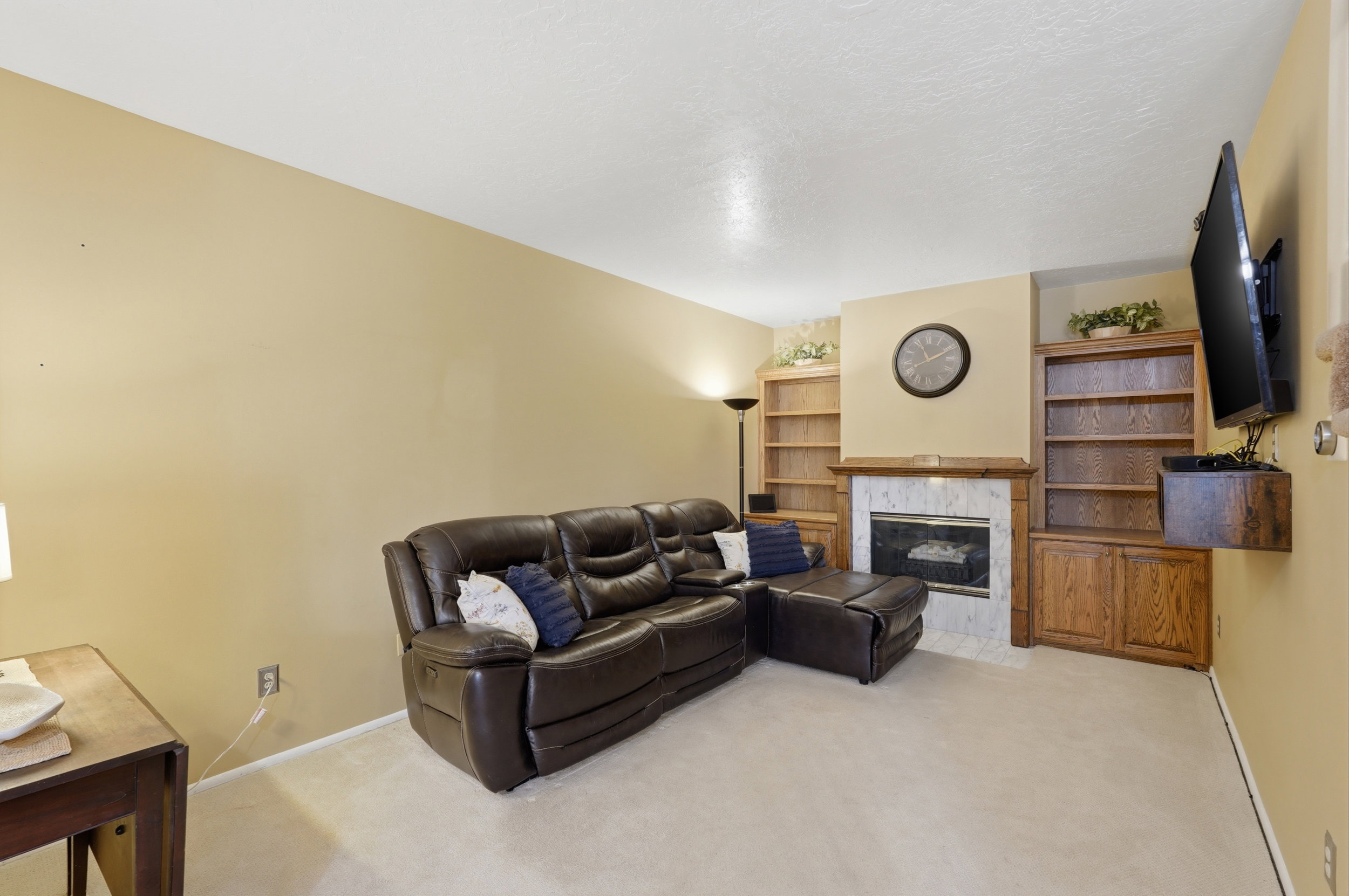 Living room with built in bookcase and fireplace.