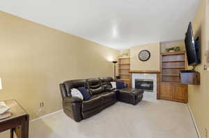 Living room with built in bookcase and fireplace.