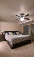 Bedroom featuring light carpet and a ceiling fan