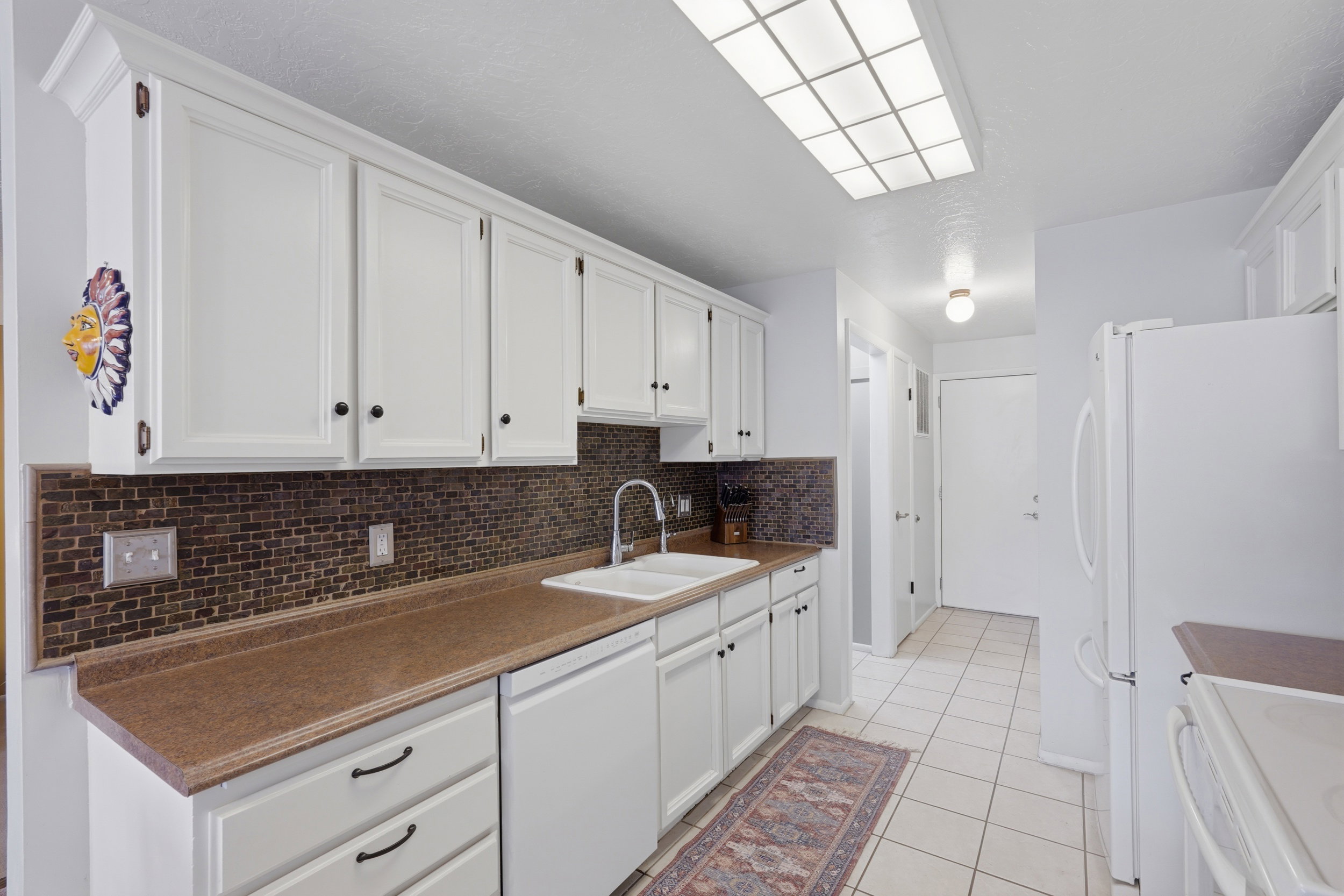 Leads to laundry, half bath and garage.