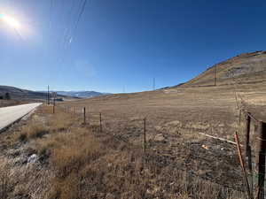 View of yard with a mountain view and a rural view