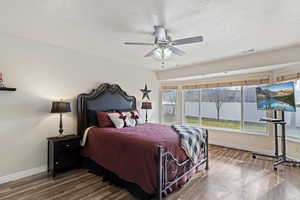 Bedroom with wood finished floors, a ceiling fan, and a textured ceiling