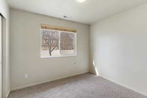 Spare room with baseboards and carpet