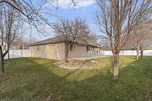 View of property exterior featuring a fenced backyard, a patio area, and a gate