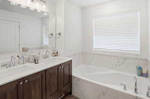Bathroom with double vanity and a bath