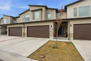 View of front of property with stone siding and stucco siding
