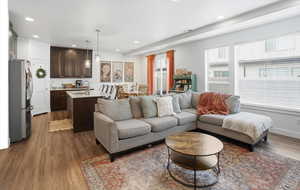 Living area featuring dark wood-type flooring and recessed lighting
