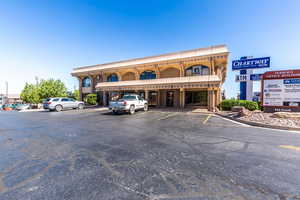View of commercial property featuring uncovered parking