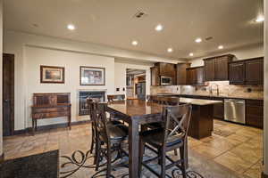 Dining space featuring recessed lighting and light tile patterned floors