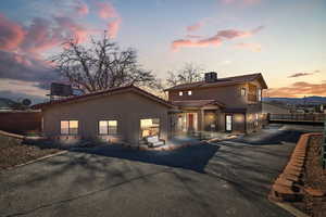 View of front of house featuring a fenced backyard, stucco siding, and a tile roof