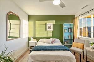 Bedroom featuring wood finished floors and ceiling fan