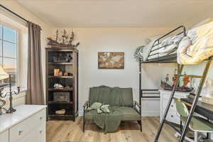 Bedroom featuring light wood-style flooring and baseboards