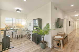 Corridor featuring recessed lighting and light wood-style flooring