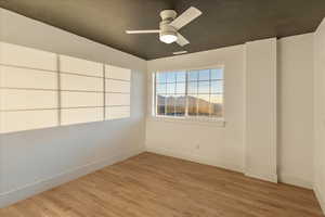 Unfurnished room featuring light wood finished floors and ceiling fan