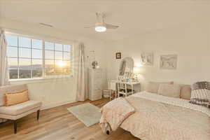 Bedroom with wood finished floors and ceiling fan
