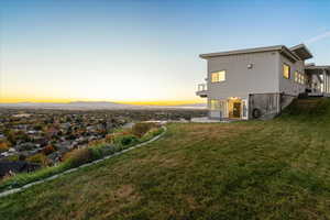 Rear view of property with a yard and a patio