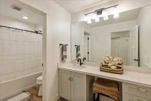 Bathroom with vanity, shower / bath combo with shower curtain, and light wood-type flooring