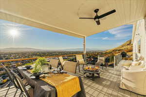 View of patio / terrace with a mountain view, a ceiling fan, and outdoor dining space
