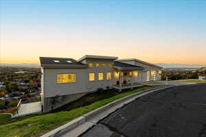 View of front of home featuring covered porch, board and batten siding, a gate, and driveway