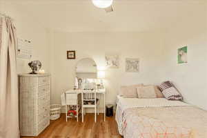 Bedroom with wood finished floors and a ceiling fan