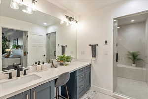 Full bathroom featuring vanity, a shower stall, connected bathroom, light tile patterned floors, and recessed lighting
