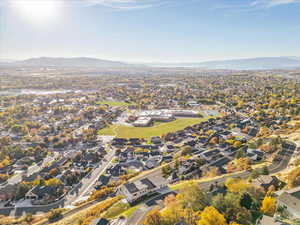 Aerial view of property's location featuring nearby suburban area and mountains