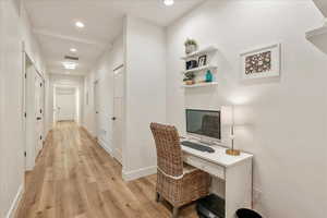Home office featuring light wood-type flooring and recessed lighting