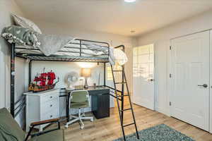 Bedroom featuring light wood-style flooring and a desk