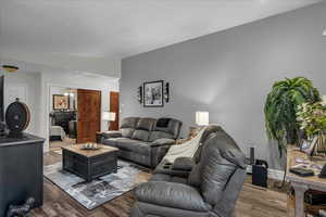Living area with wood finished floors and baseboards