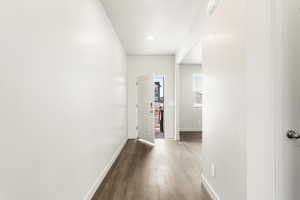 **DISCLAIMER** Interior color package may vary.Hallway with baseboards and dark wood-type flooring