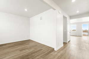 **DISCLAIMER** Interior color package may vary.Spare room with light wood-style floors and recessed lighting