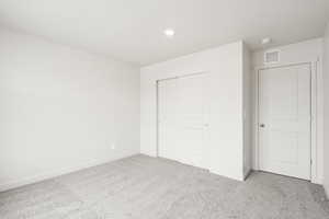 **DISCLAIMER** Interior color package may vary.Unfurnished bedroom featuring carpet and a closet