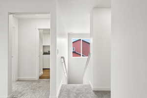 **DISCLAIMER** Interior color package may vary.Staircase with carpet flooring and baseboards