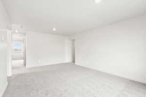 **DISCLAIMER** Interior color package may vary.Unfurnished room featuring light colored carpet and recessed lighting
